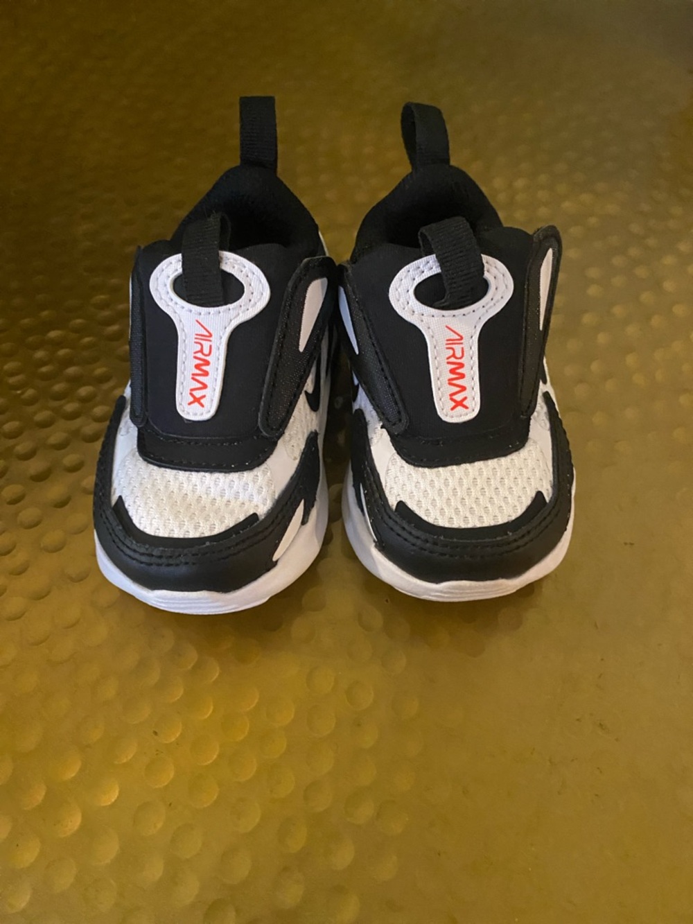 Nike babys Black and White Air Max Slip-On Sneakers with Orange-Red Logo